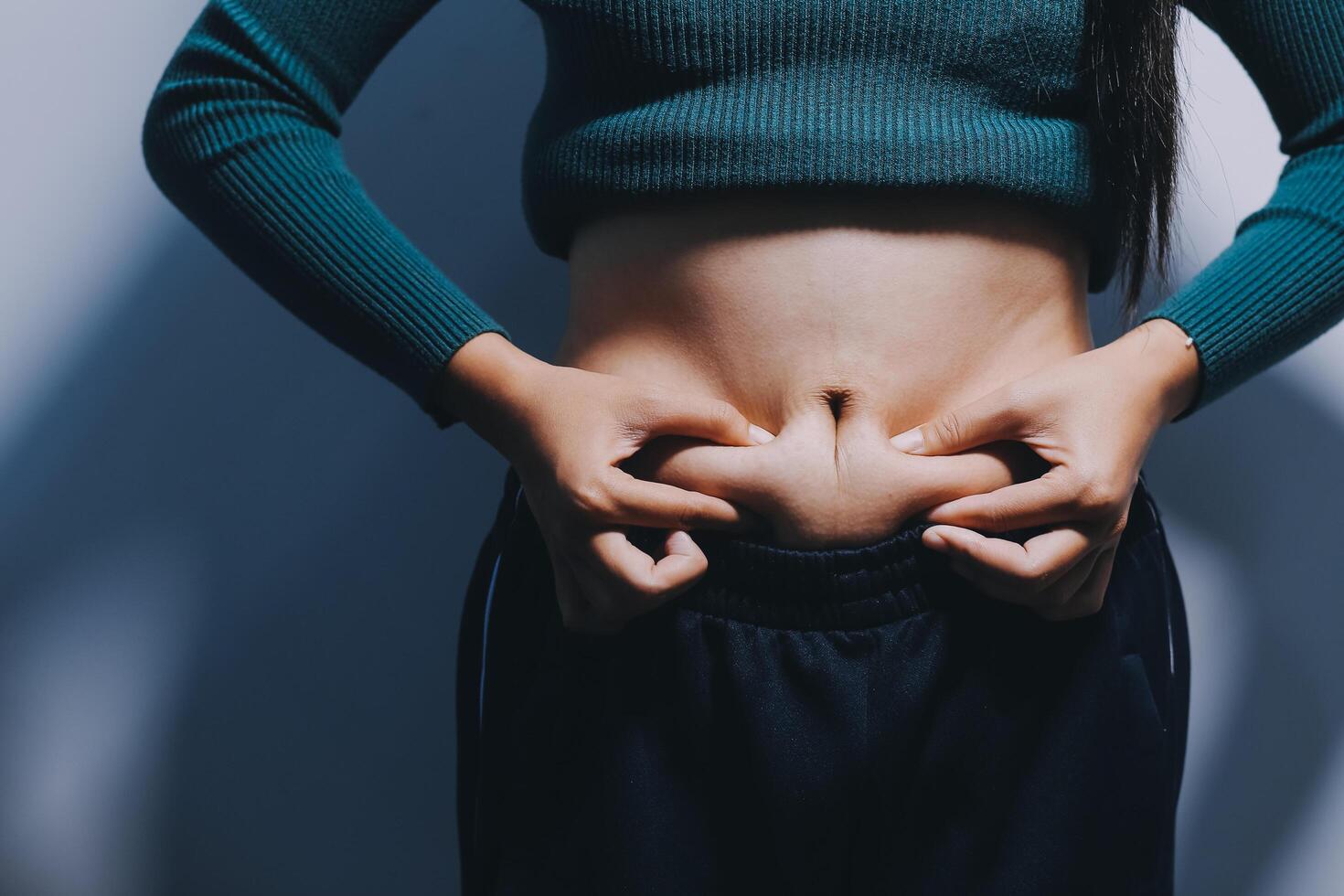 A woman with her hands on her stomach photo