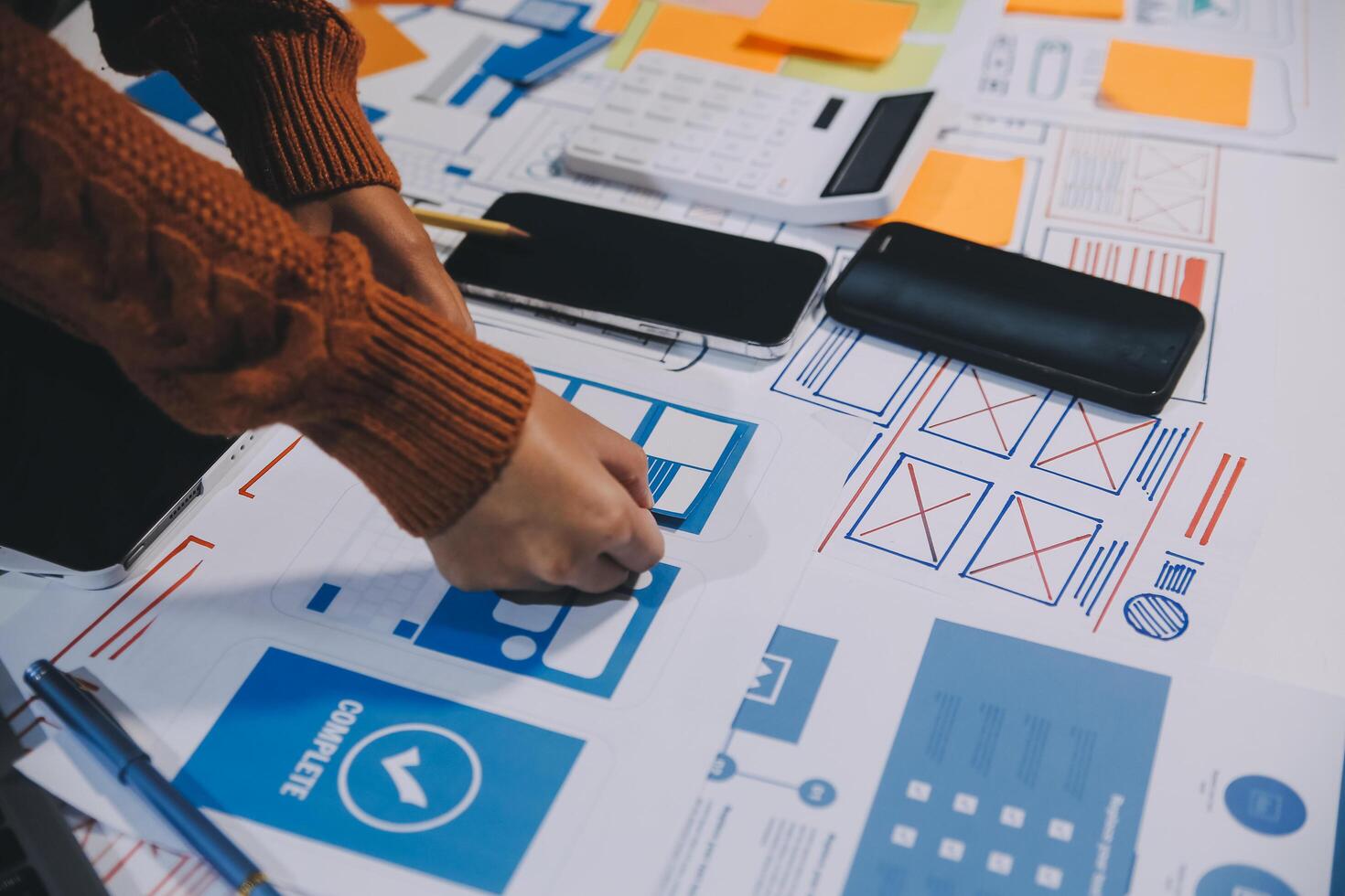 A person is working on a design project on a table photo