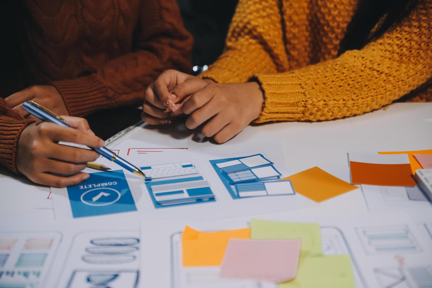 Two people working on a project at a table photo