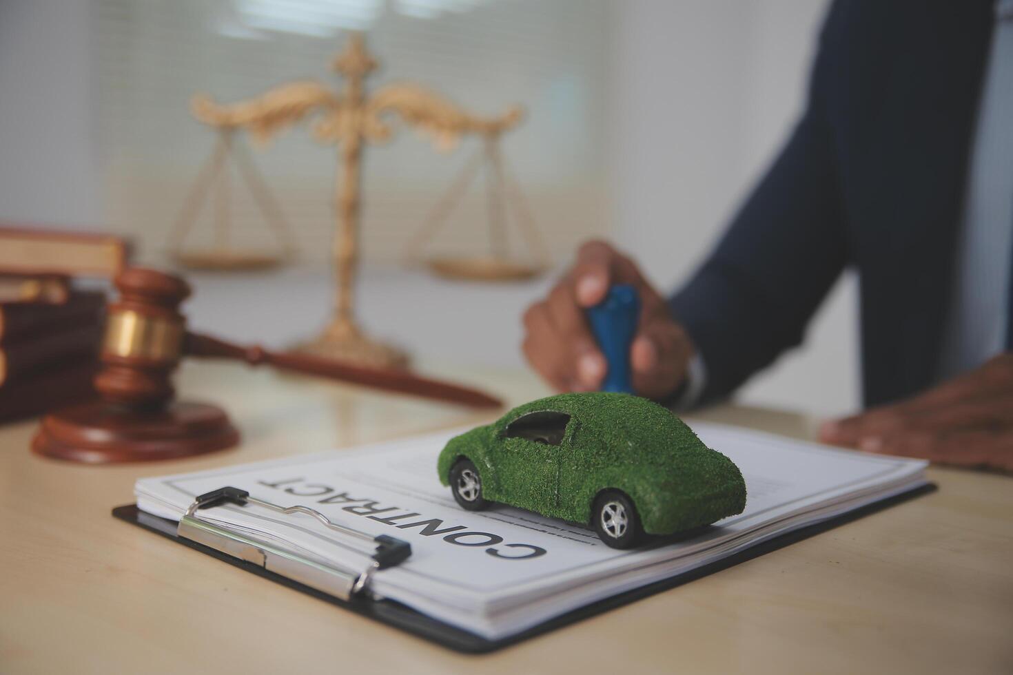 A man in a suit is signing a contract with a car on it photo