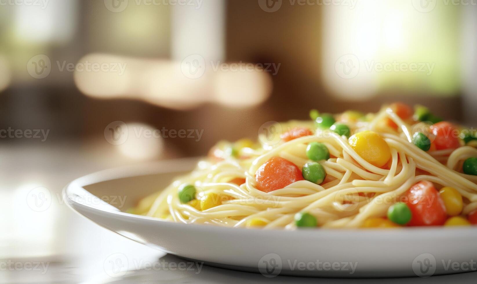 A plate of pasta with peas and carrots photo