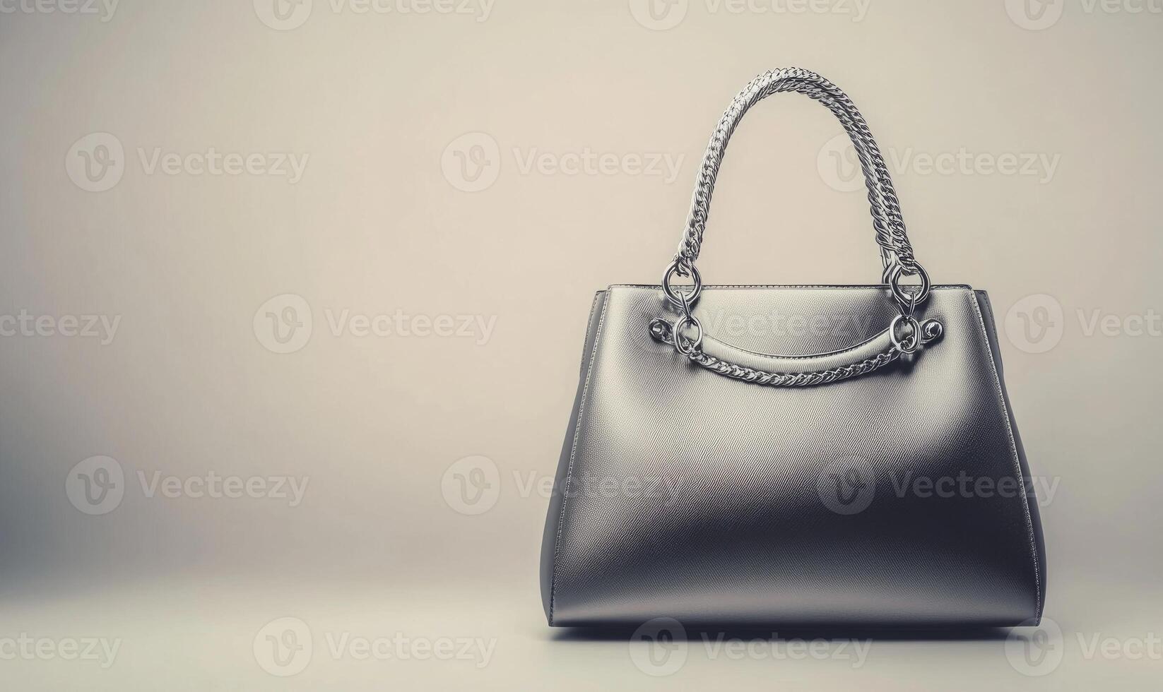 A silver purse with a gold chain strap photo