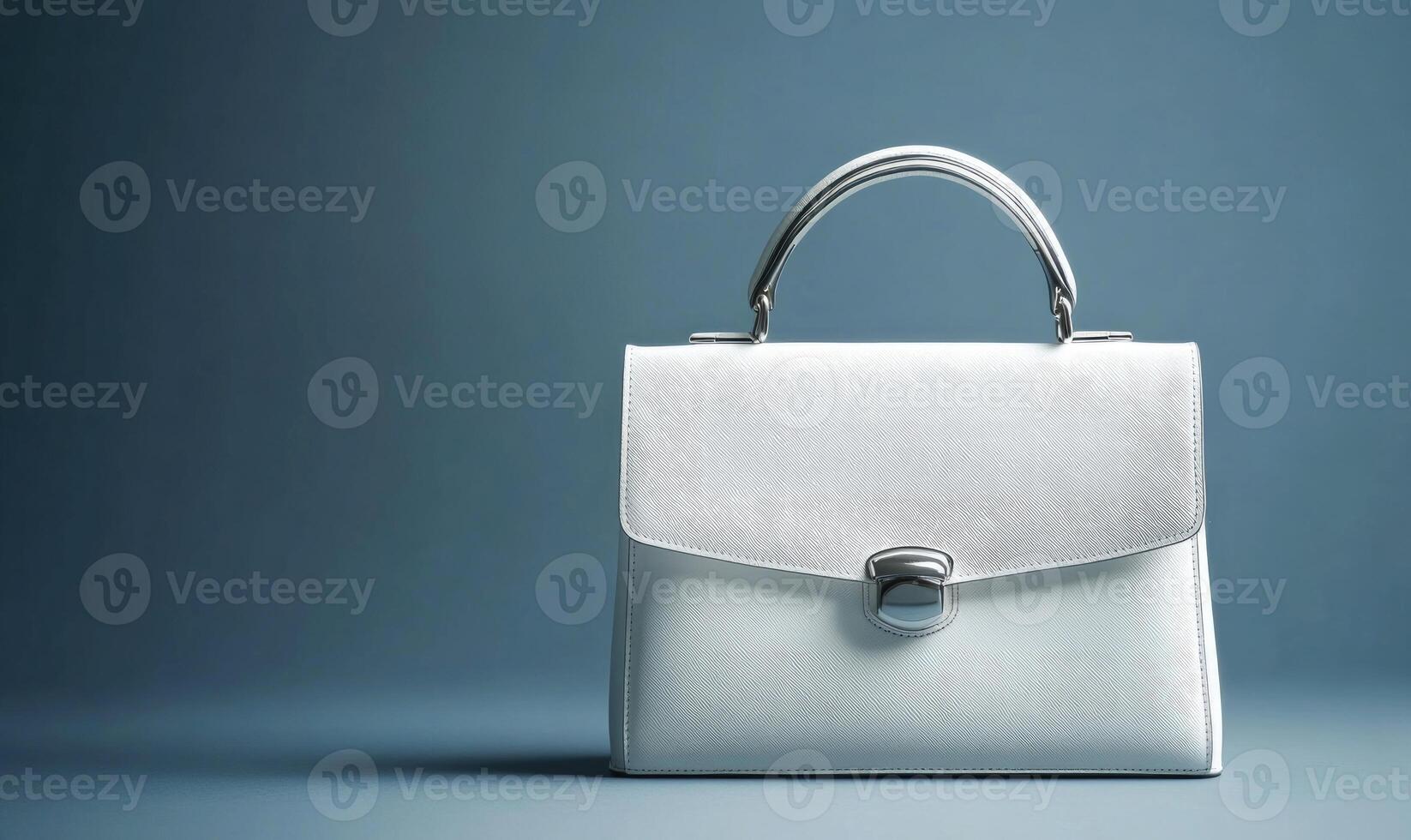 A white purse with a silver handle photo