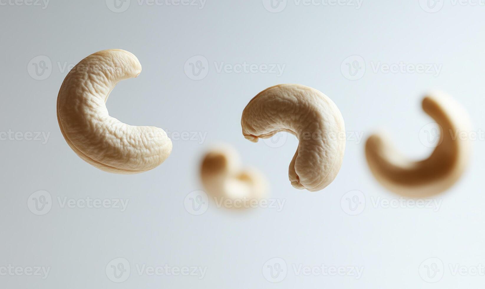 Three cashews are flying in the air closeup view photo