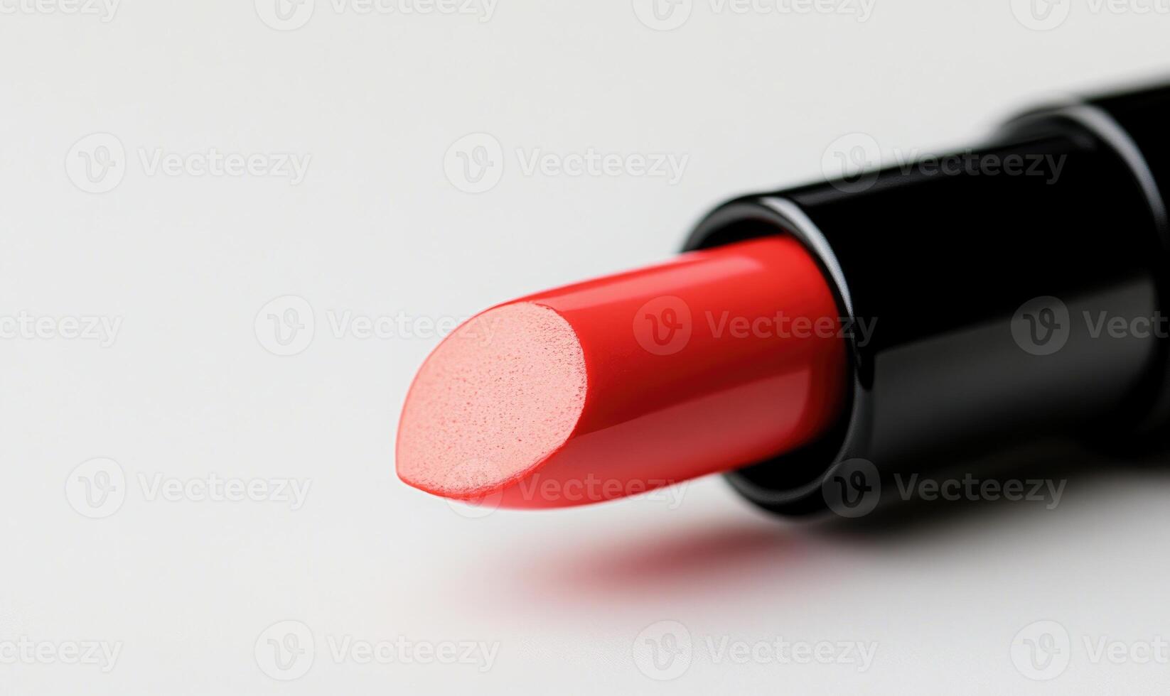 A red lipstick is shown on a white background photo
