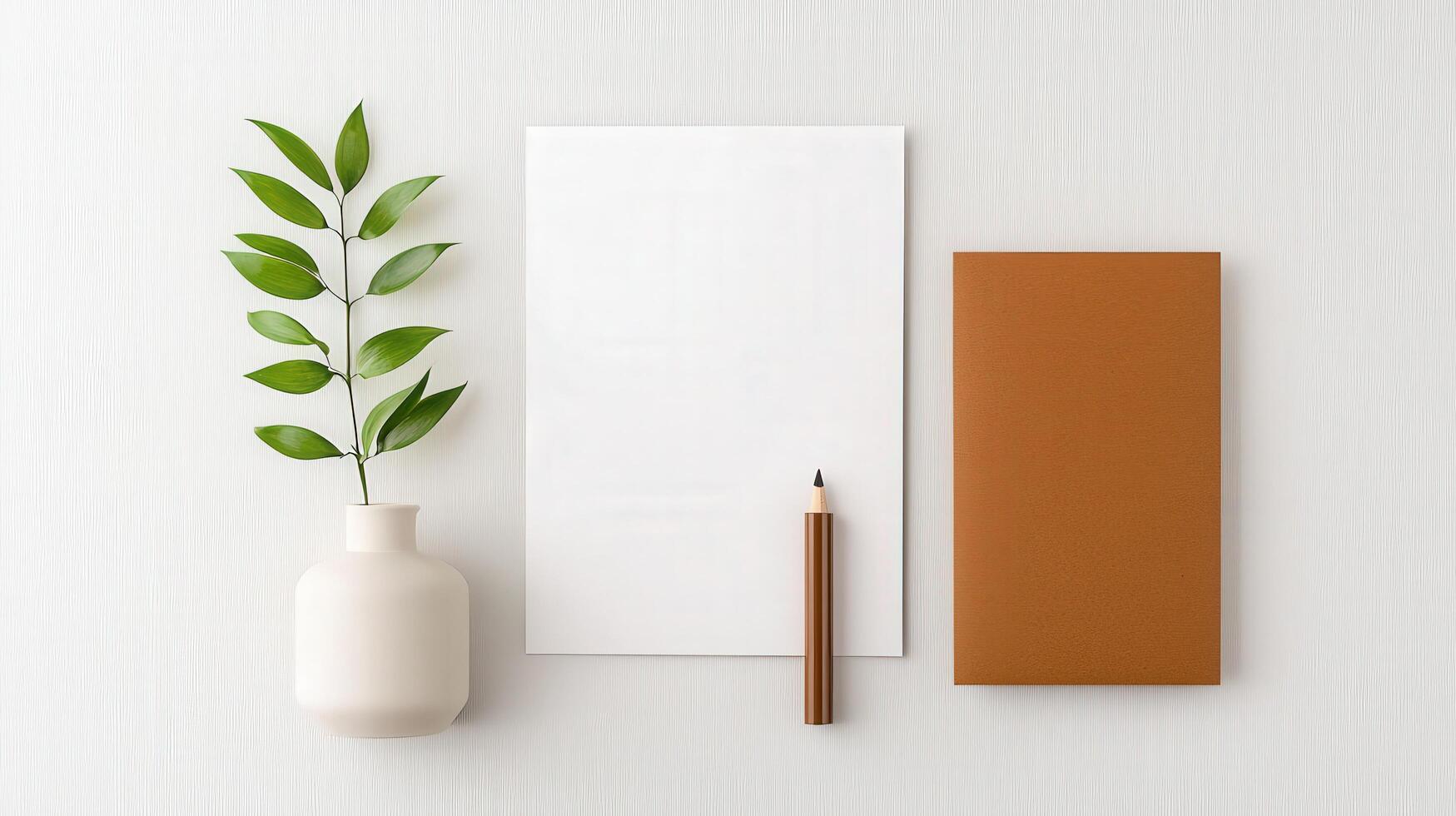 A white notebook sits on a table next to a pencil and a potted plant photo