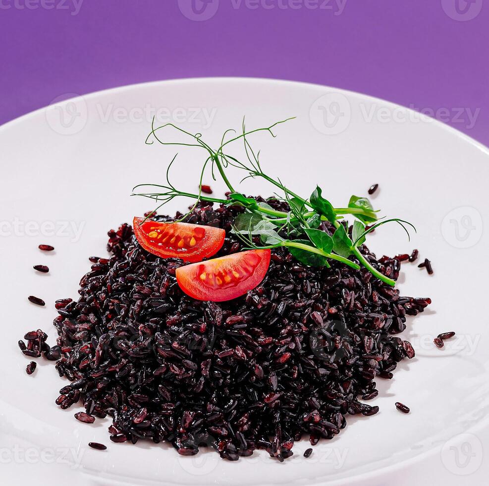 Savoring healthy black rice with fresh tomatoes and herbs on a plate photo