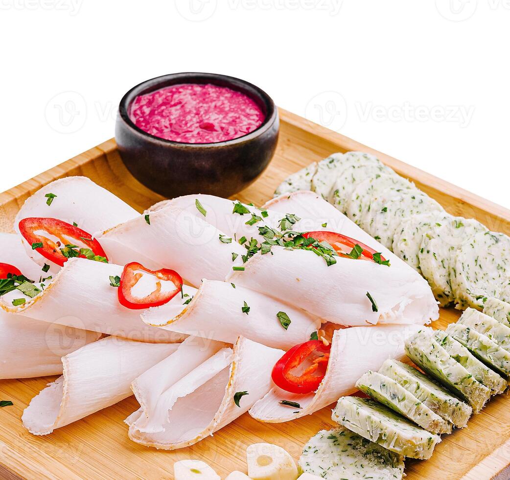 Fresh and vibrant platter featuring assorted cold cuts and herbs photo