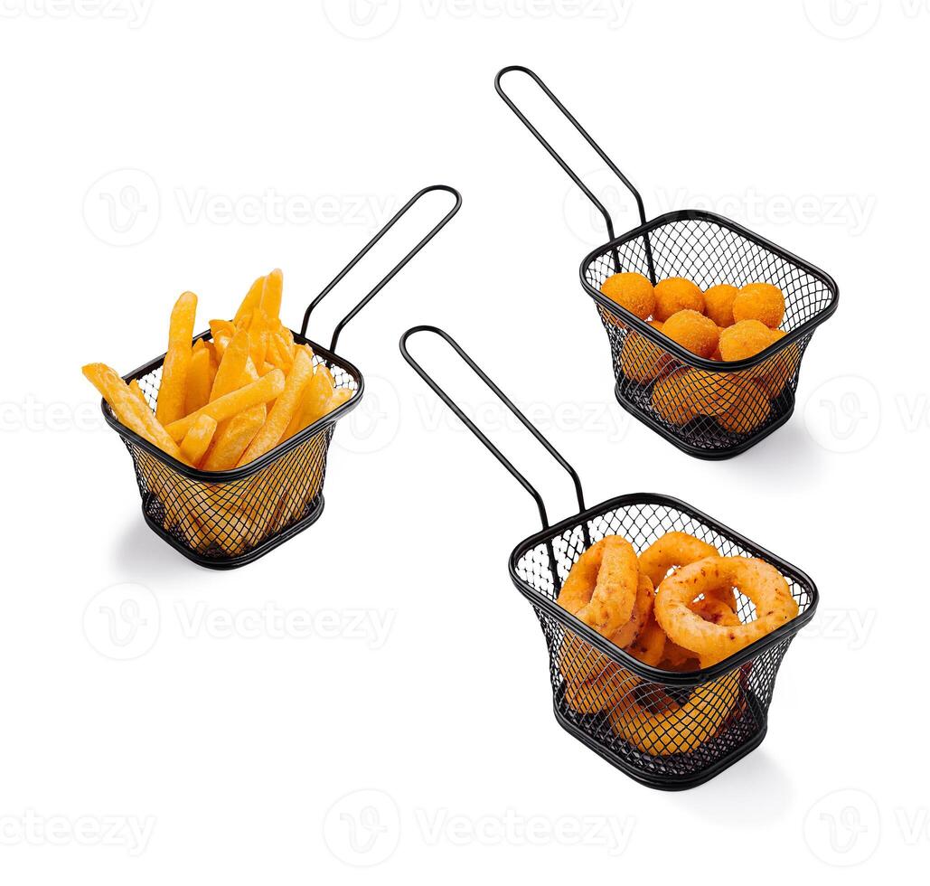 Three serving baskets with various fried snacks on a table photo