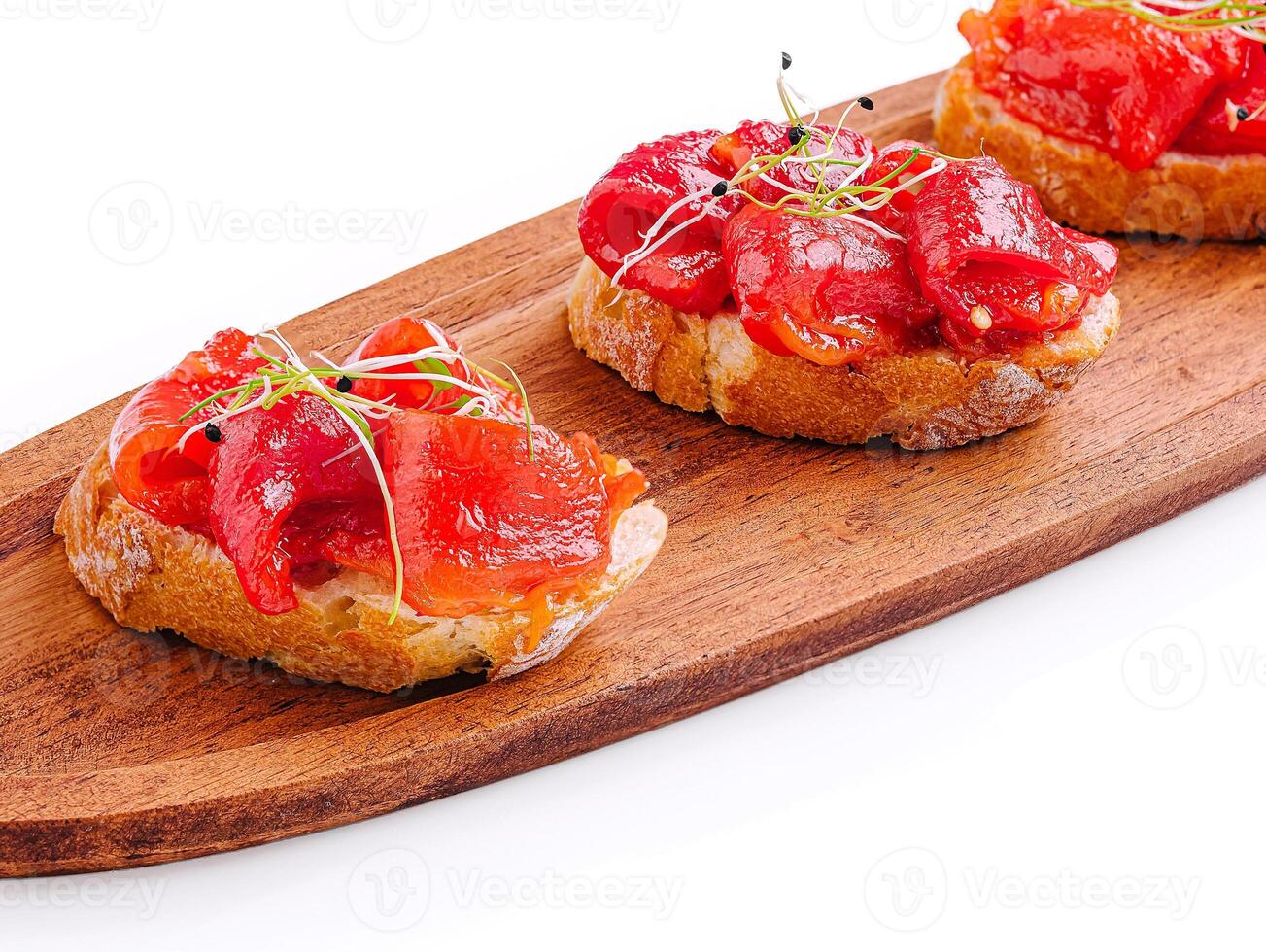Delicious tapas served on wooden platter with vibrant toppings photo