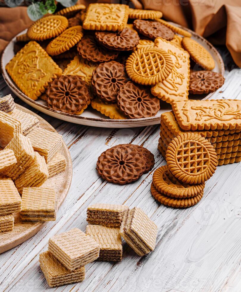 Assorted cookies piled on plates for a delightful dessert spread photo