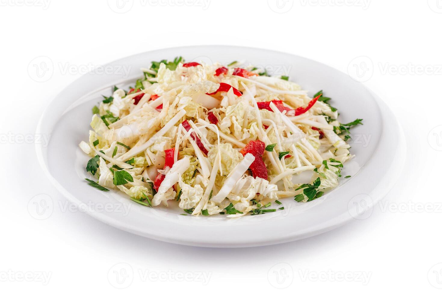 Fresh napa cabbage salad with red bell pepper and parsley on white plate photo