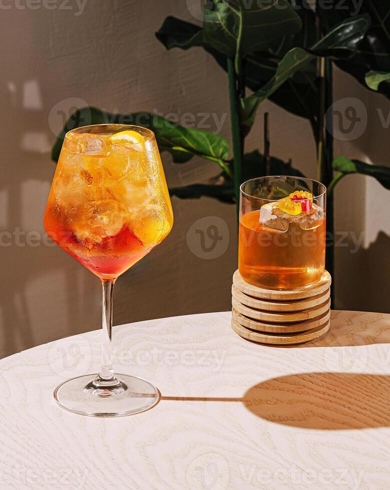 Refreshing cocktails on a wooden table with green plants photo