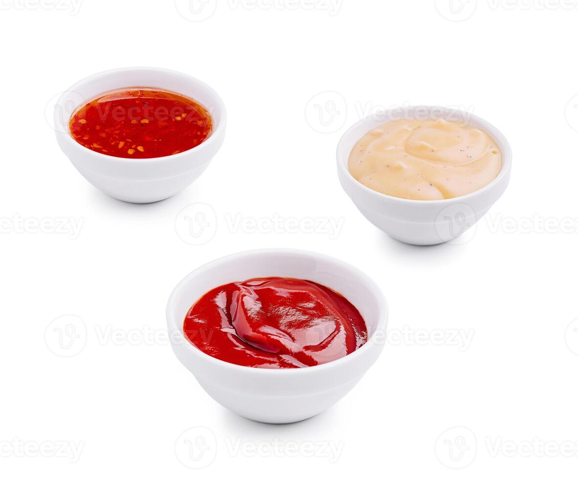 Three bowls of various sauces on a white background photo