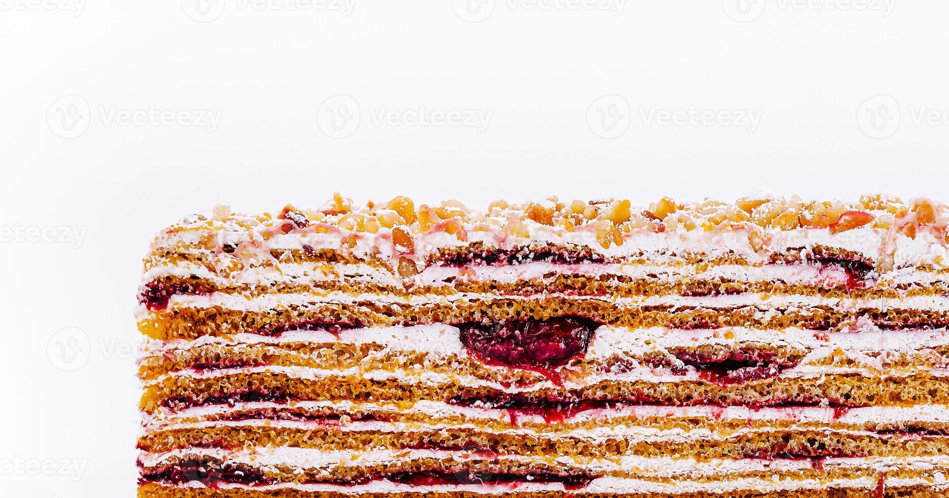 Layers of delicious dessert with raspberry filling and cream photo