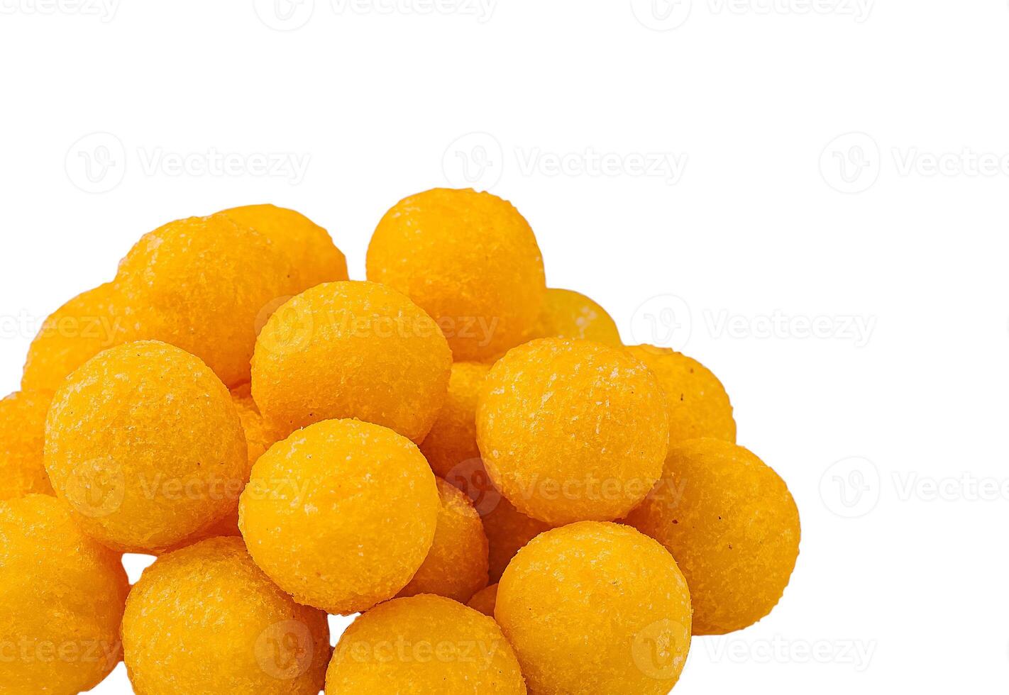 Bright yellow cheese balls stacked on a white background photo