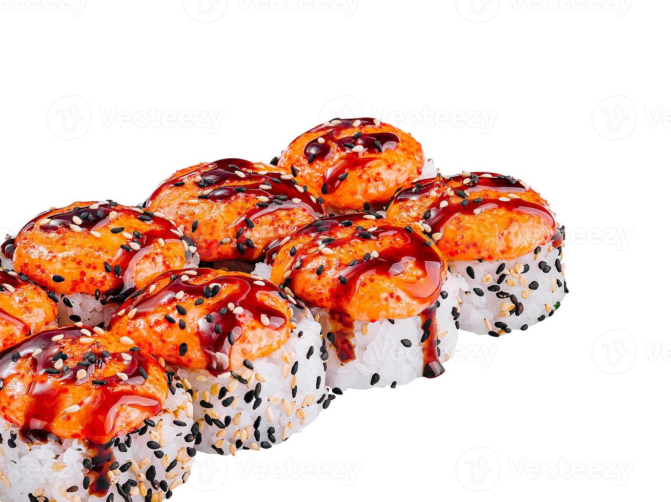Sushi rolls topped with spicy sauce and sesame seeds photo