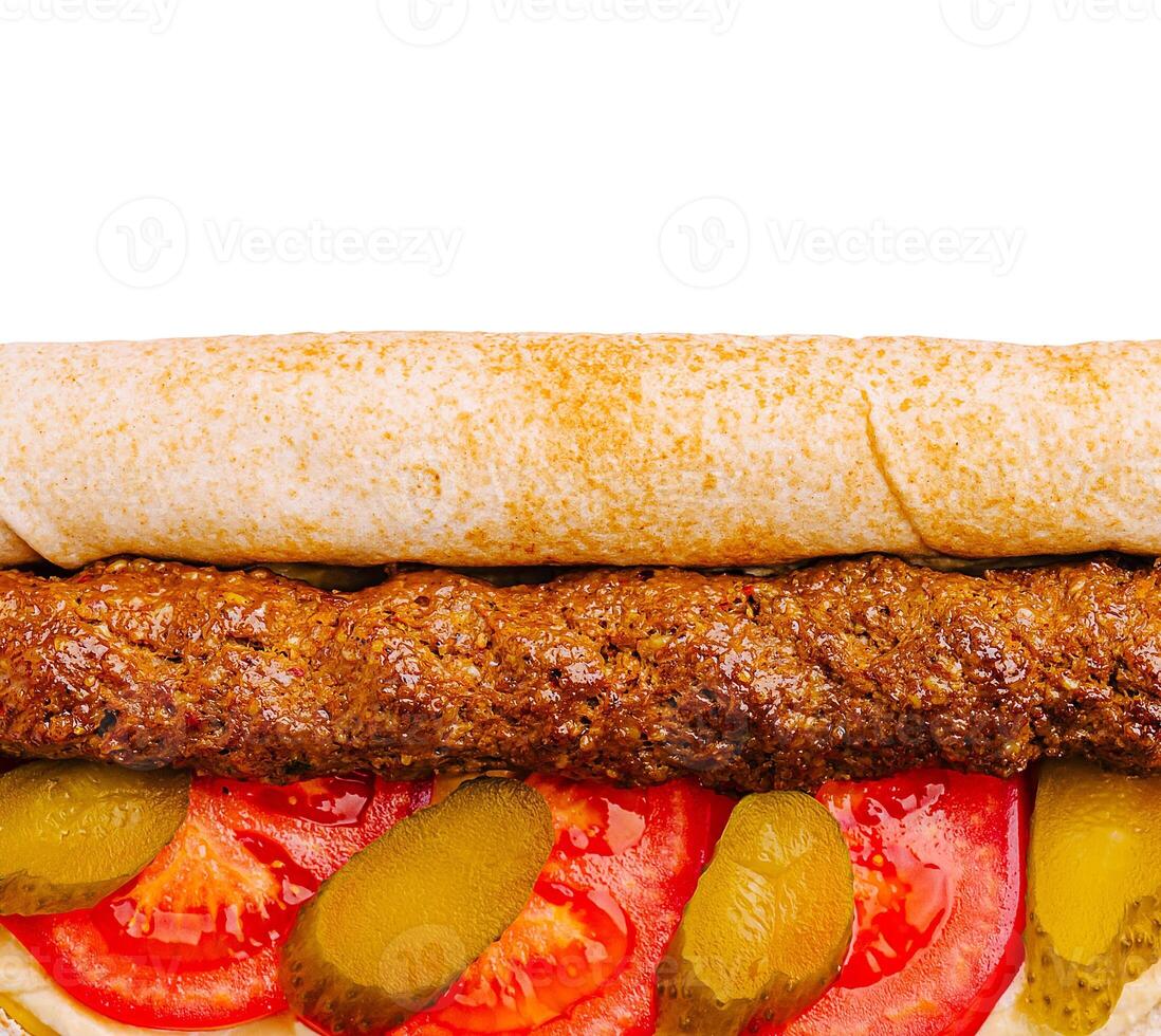 Delicious kebab wrap with fresh vegetables and sauces photo