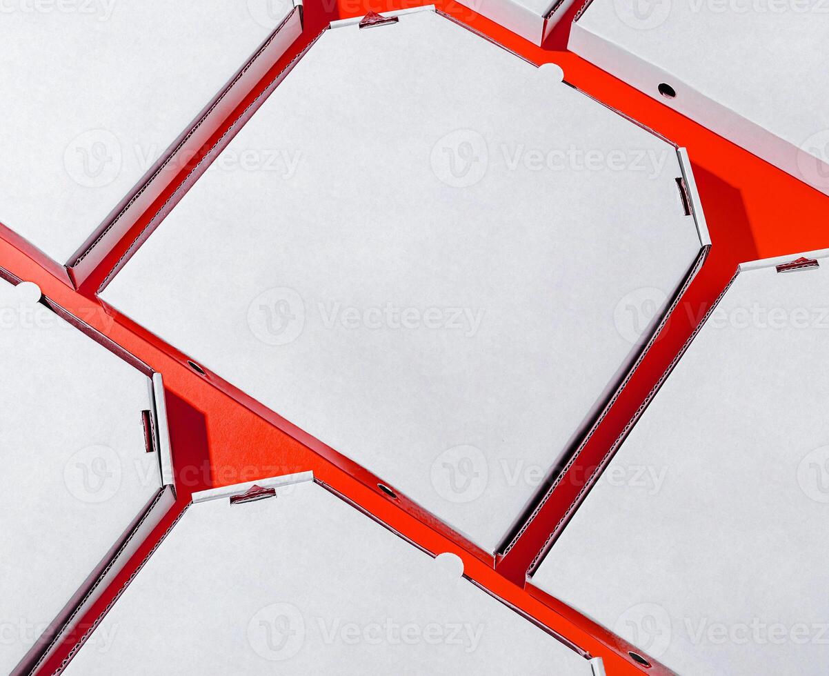 Empty pizza boxes arranged in a colorful pattern on a table photo