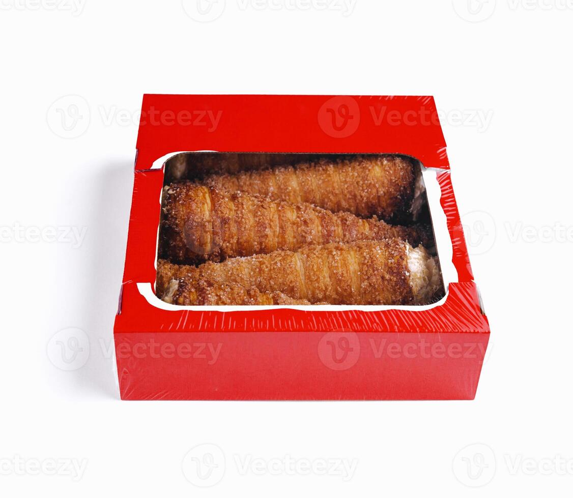 Fresh baked churros in a red box on white background photo