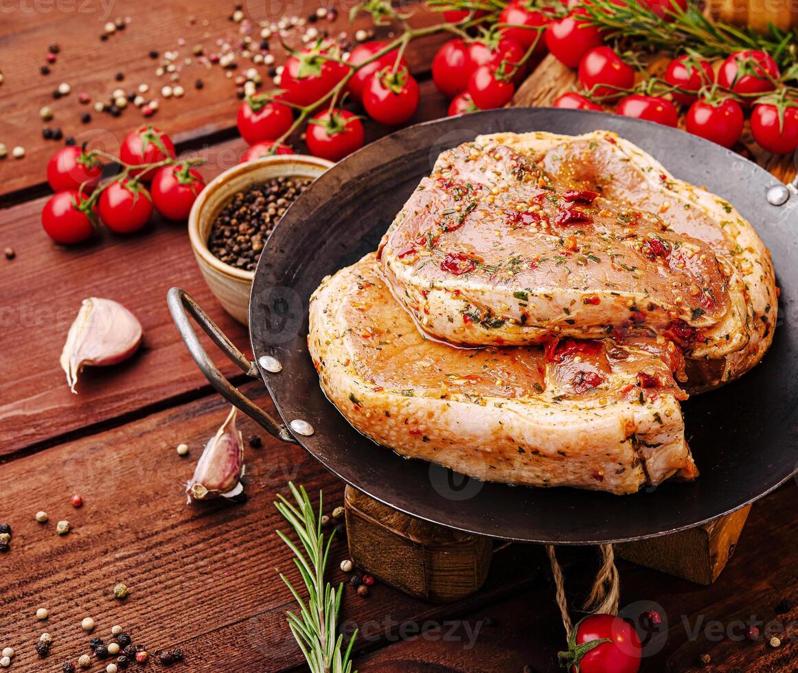 Juicy marinated meat resting on a rustic wooden table photo