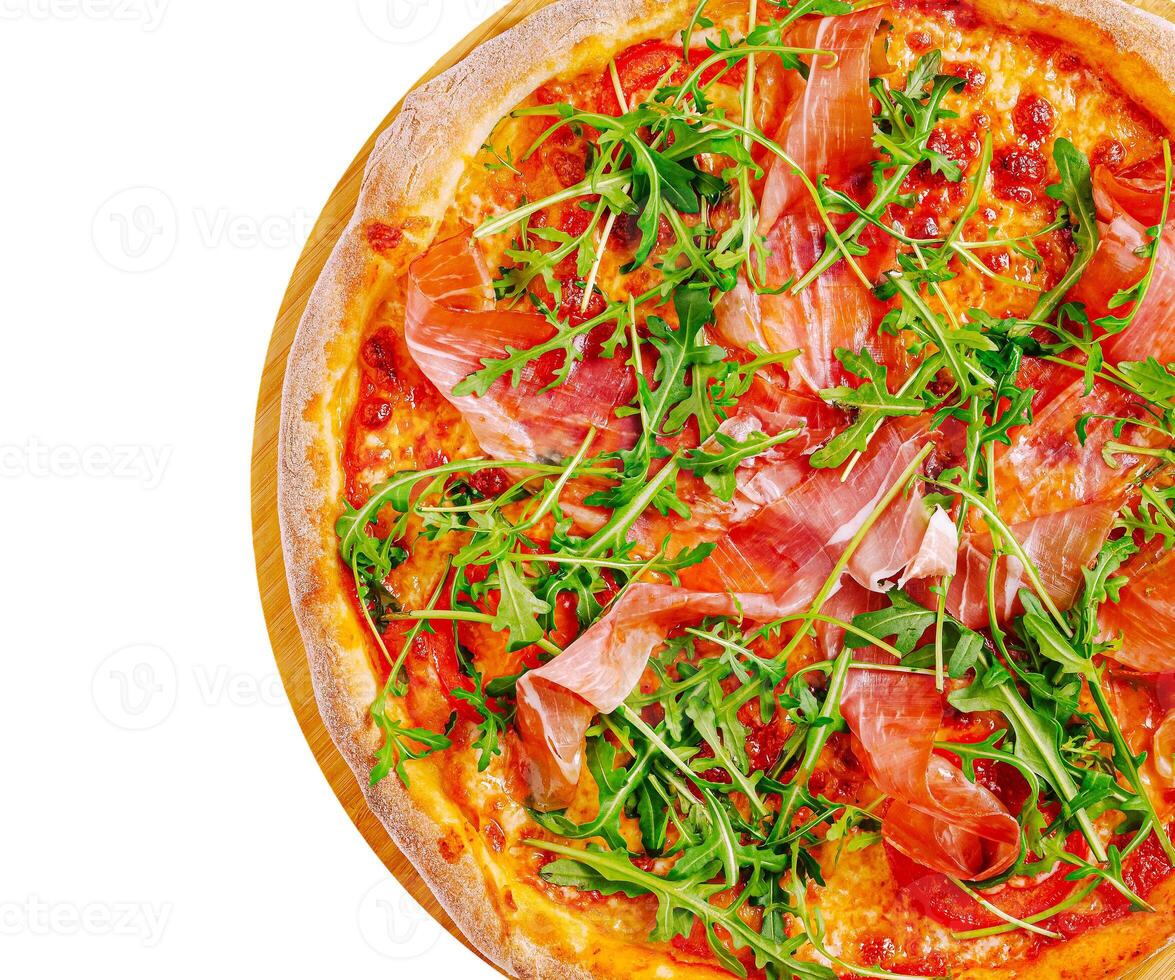 Delicious pizza topped with prosciutto and arugula on wooden board photo