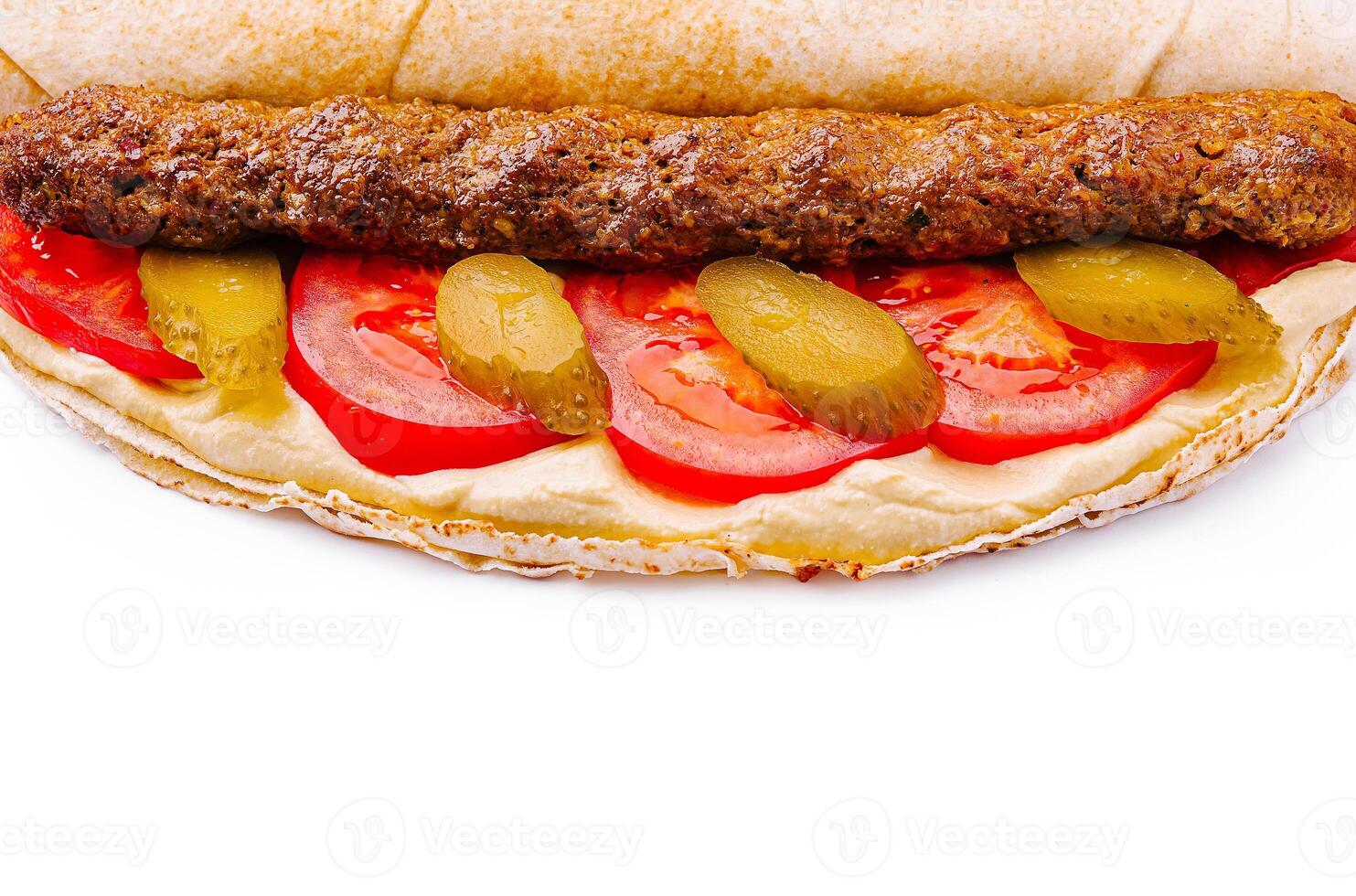 Delicious wrap filled with meat, vegetables, and sauce photo