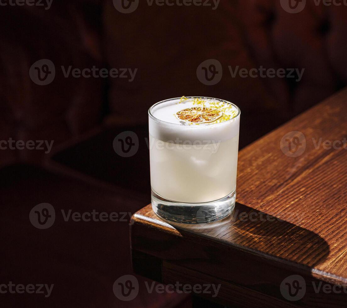 Refreshing cocktail served on wooden table in cozy setting photo