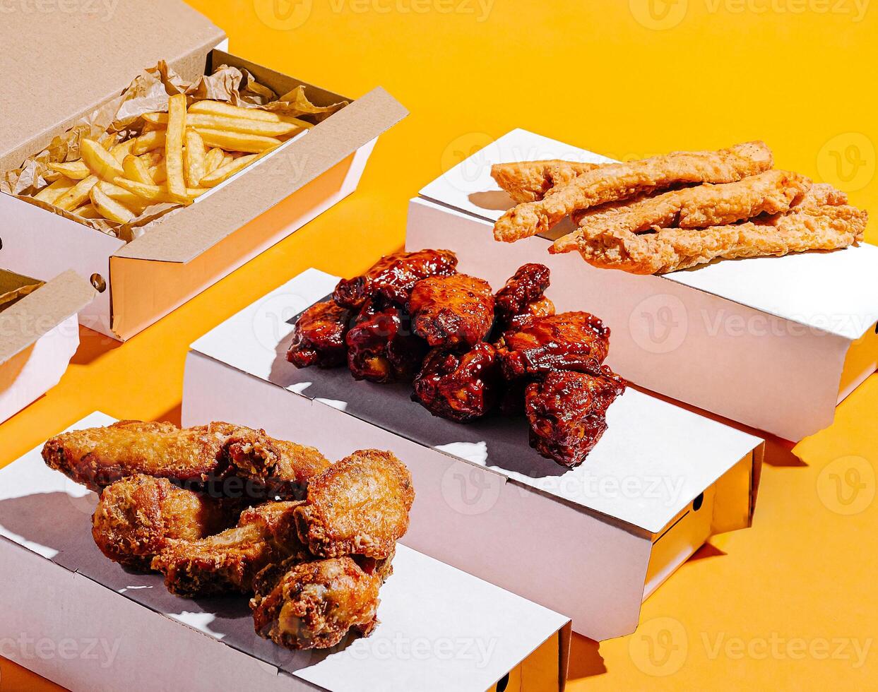 Tasty fried chicken and fries on a vibrant background photo