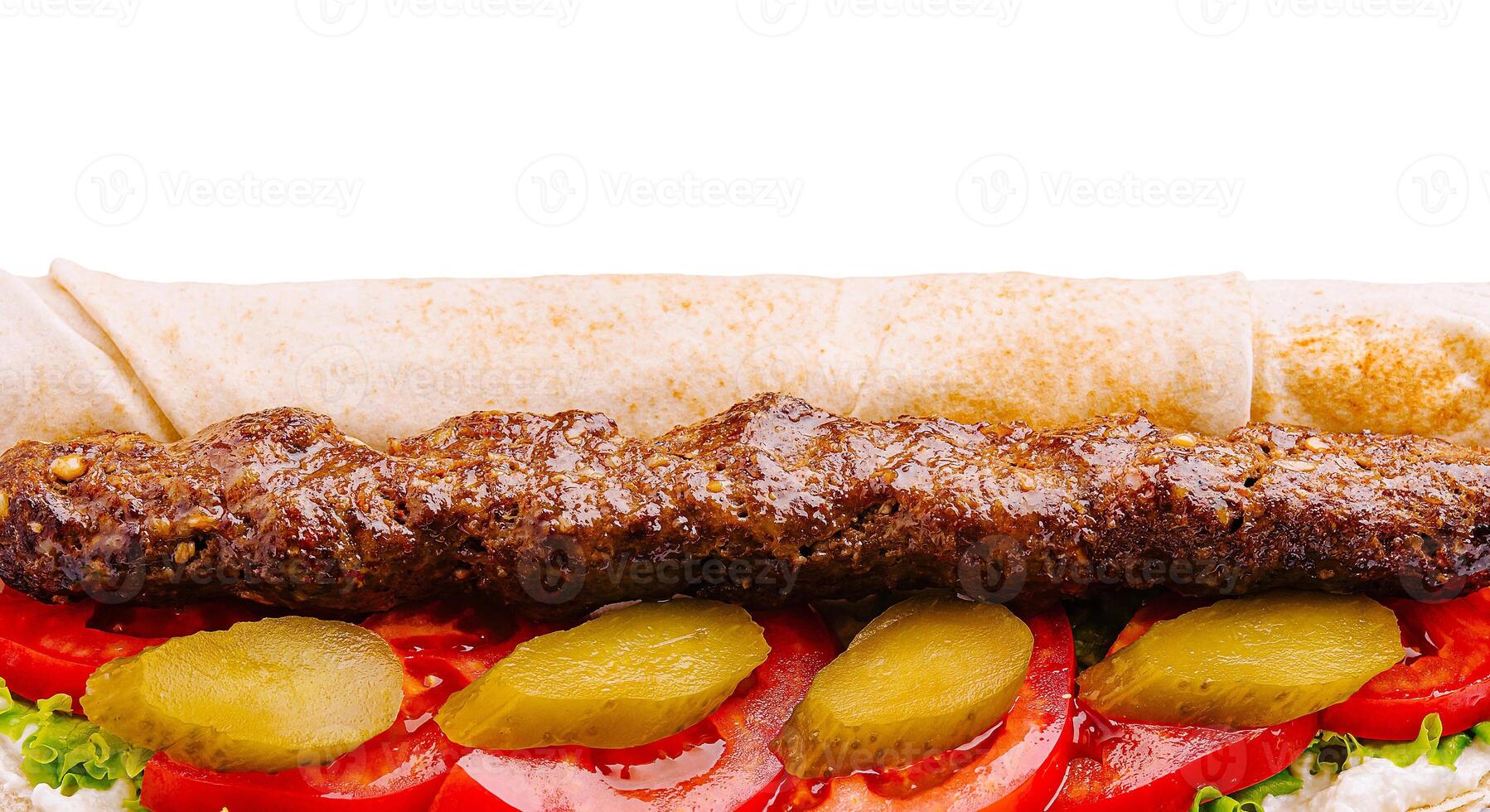 Delicious kebab sandwich with fresh vegetables and sauce photo
