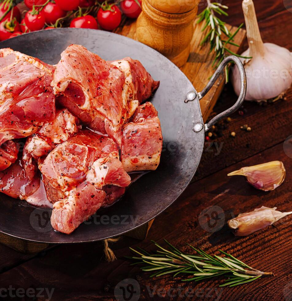 Fresh meat preparation at a rustic kitchen table with spices photo