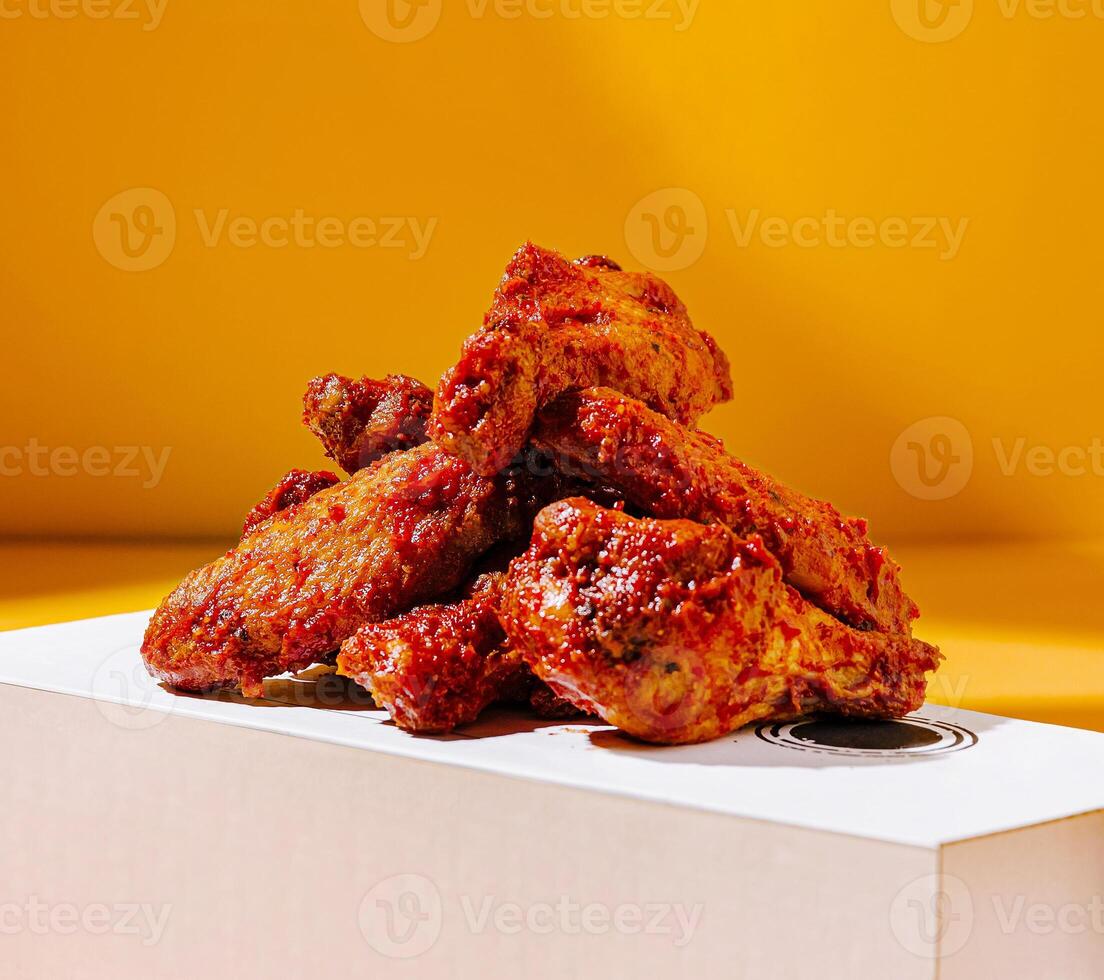 Spicy chicken wings in a bright box backdrop photo