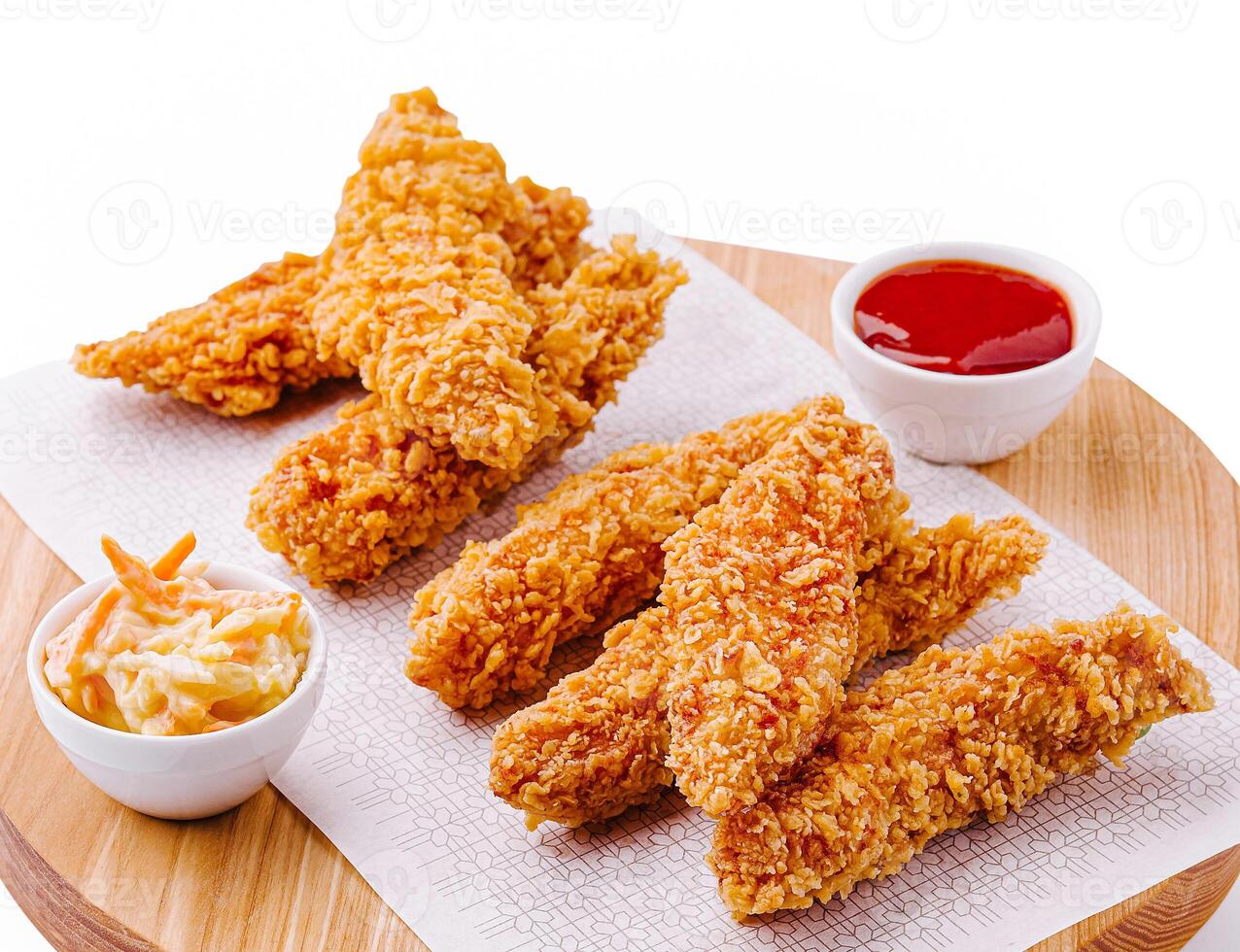 Delicious crispy chicken tenders served with dipping sauces photo