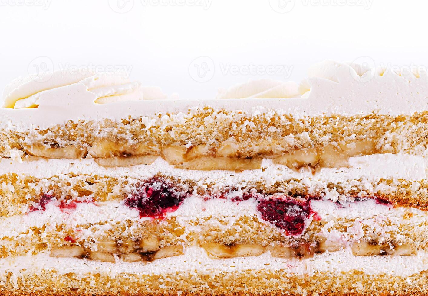 Delicious layered cake with cream, fruit, and sponge at dessert time photo