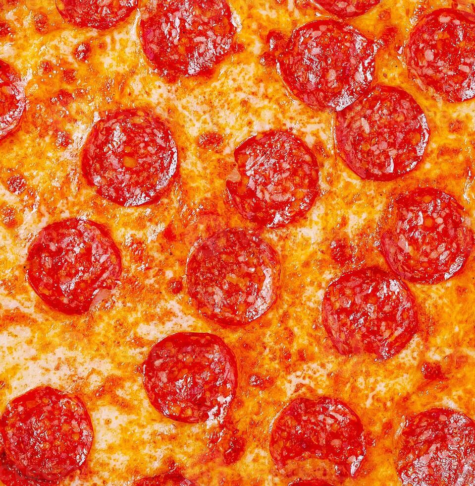 Hot pepperoni pizza fresh out of the oven with melted cheese photo