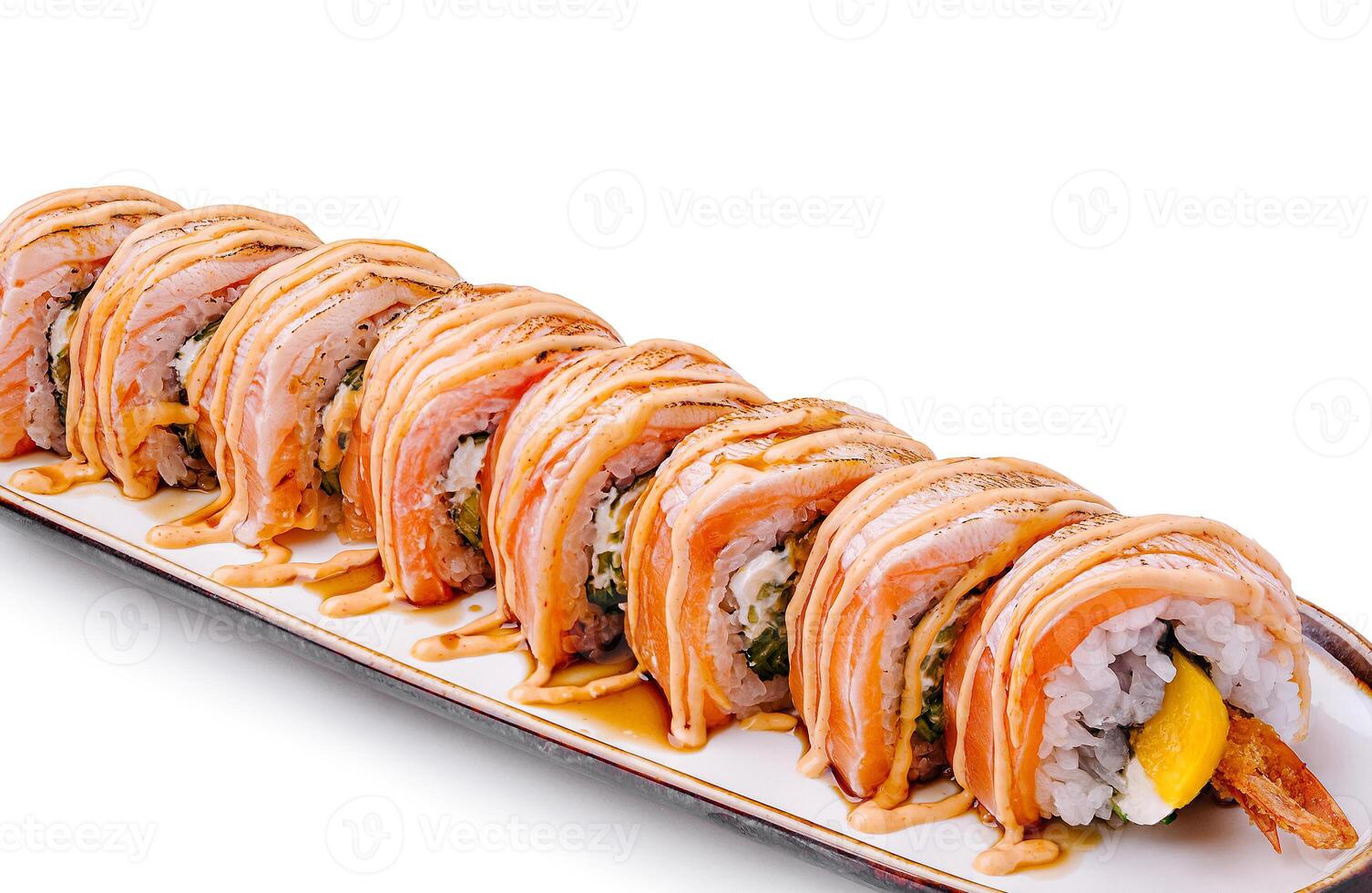 Delicious sushi rolls presented on a white plate with sauce photo