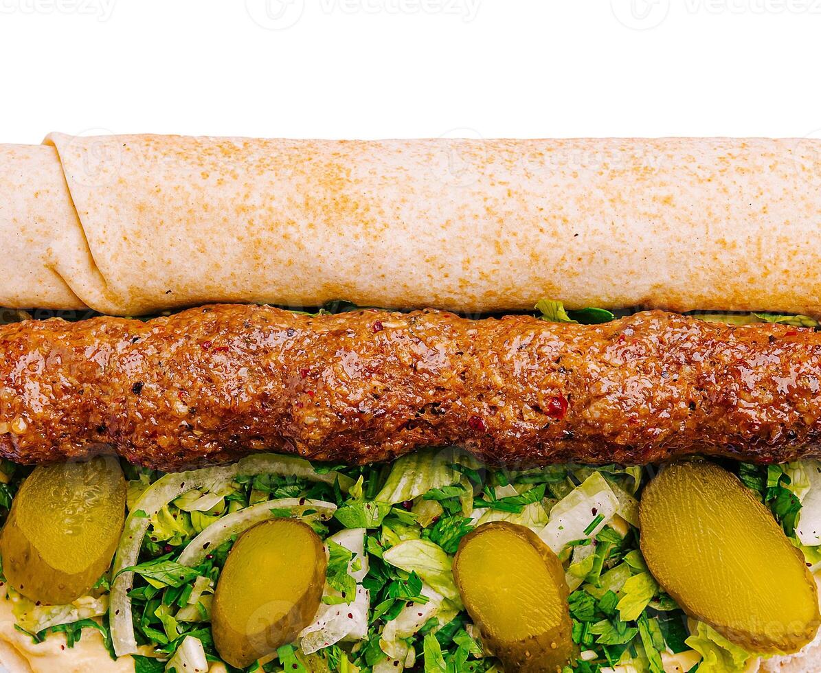 Delicious kebab roll with fresh toppings and flavored sauce photo