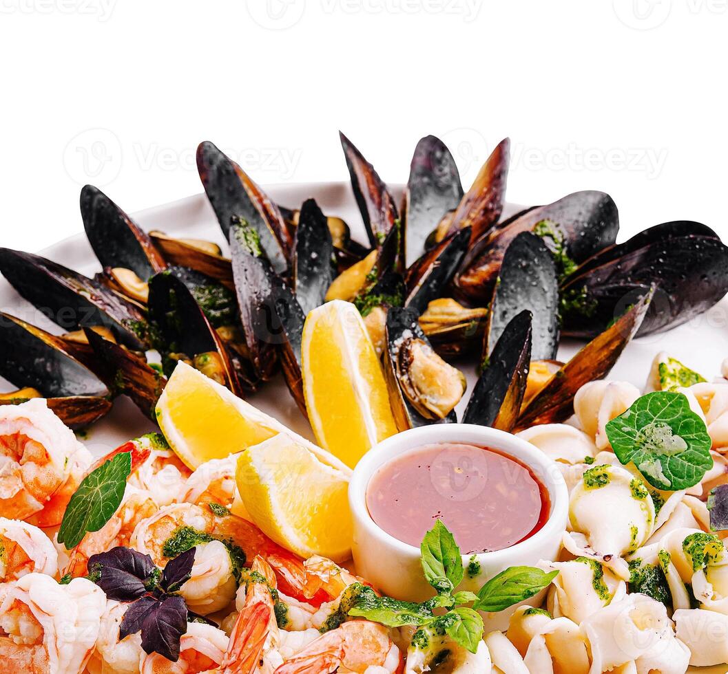 Fresh seafood platter with shrimp and mussels served with sauce photo
