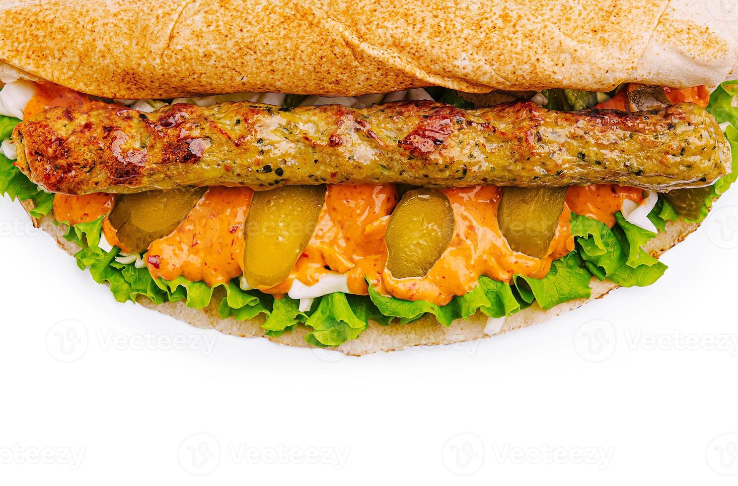 Delicious sandwich with grilled meat, fresh vegetables, and sauce photo