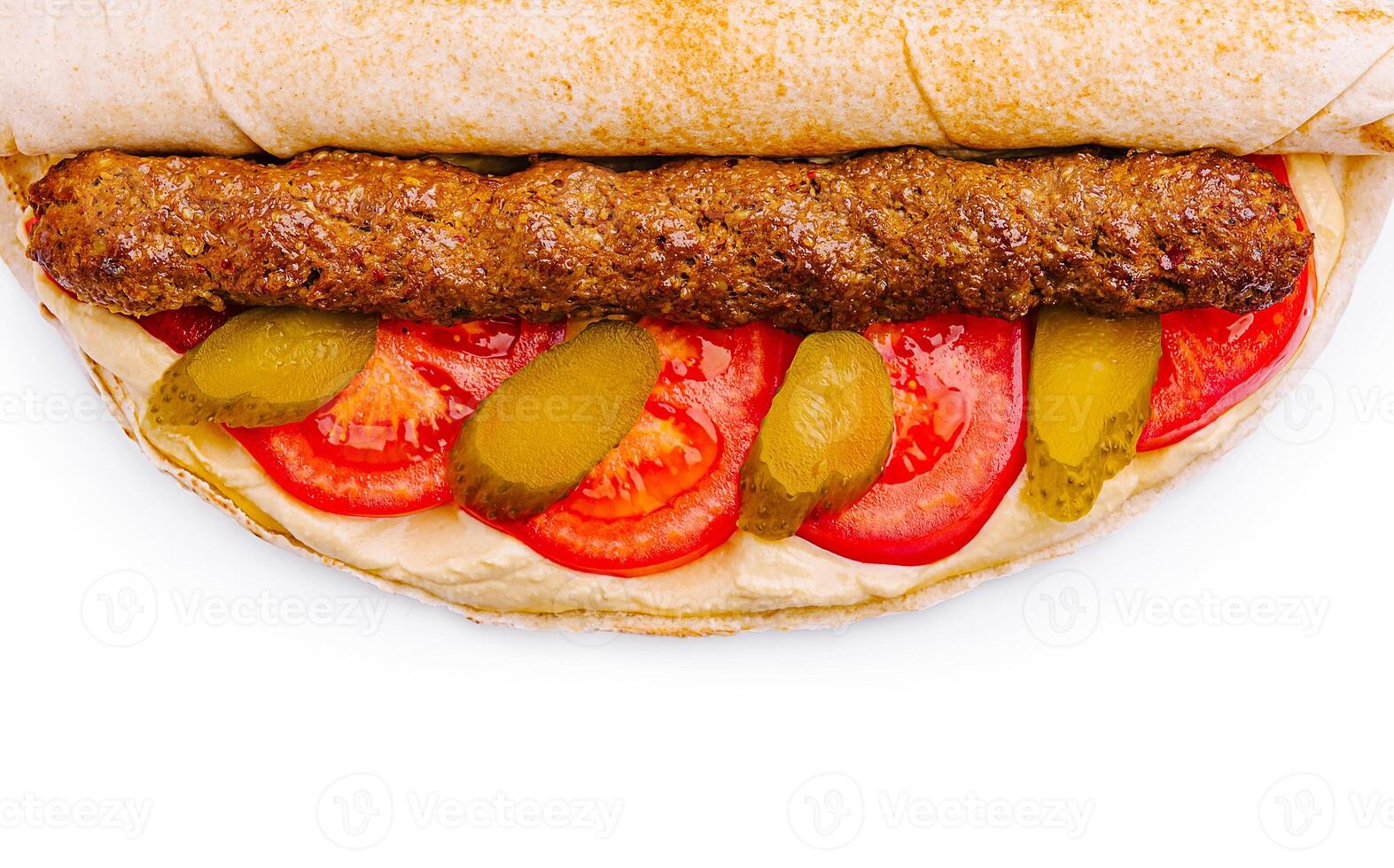 Delicious wrap with grilled meat, tomatoes, and pickles for lunch photo