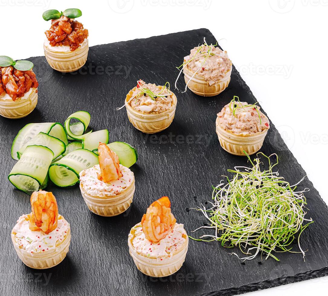 Delicious seafood appetizers displayed on a slate platter closeup photo