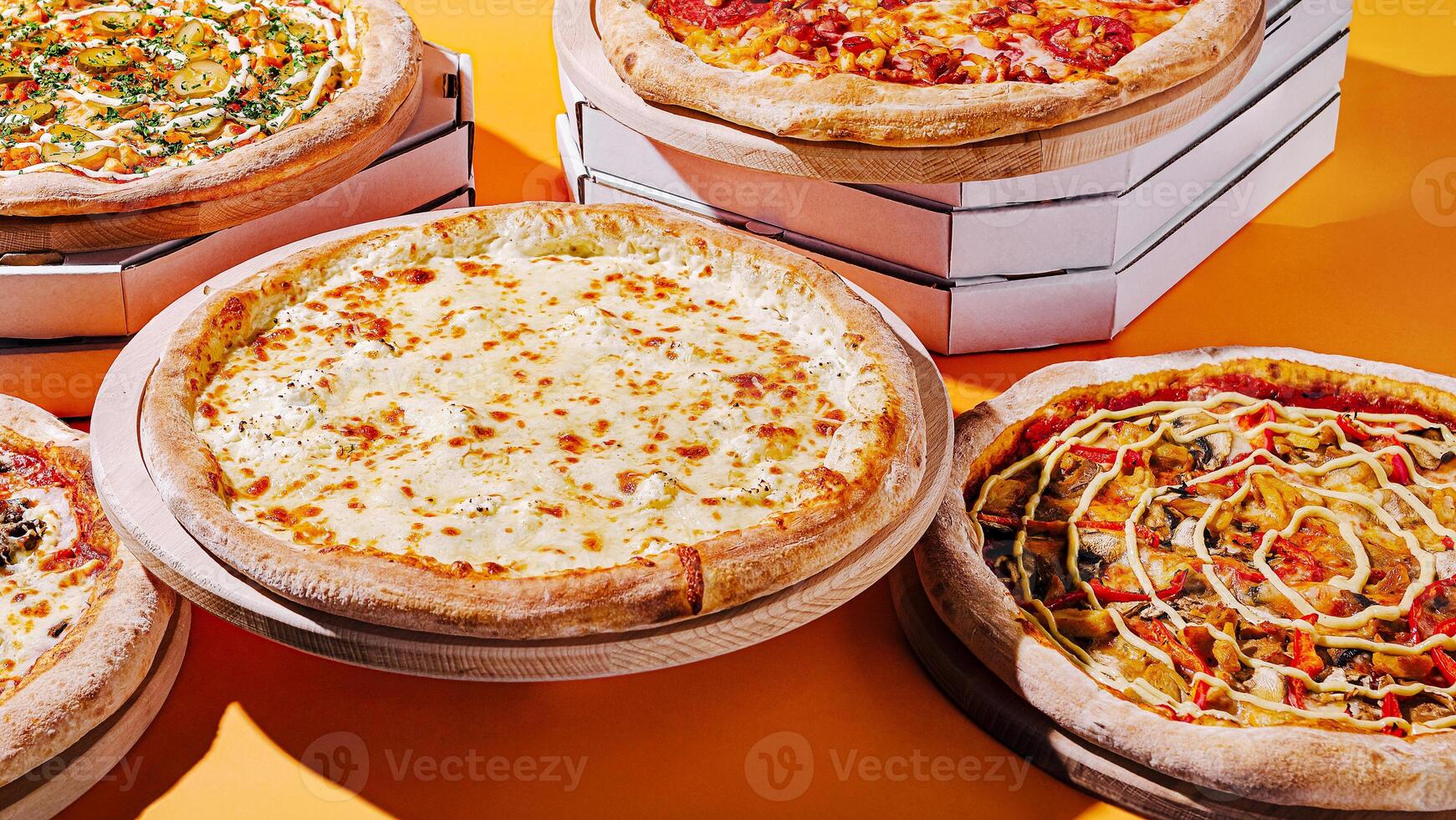 Delicious variety of pizzas displayed on colorful background photo