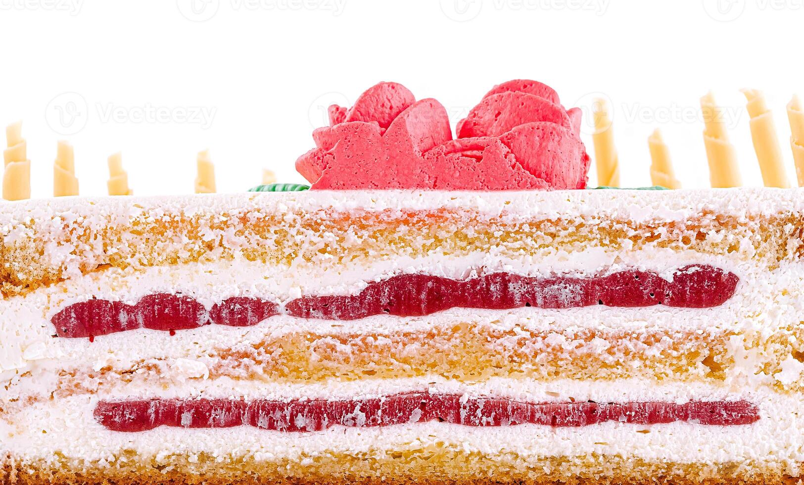 Colorful layered cake topped with decorative frosting and fruit photo