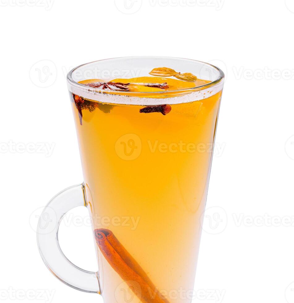 Warm drink with spices and herbs in a clear glass cup photo