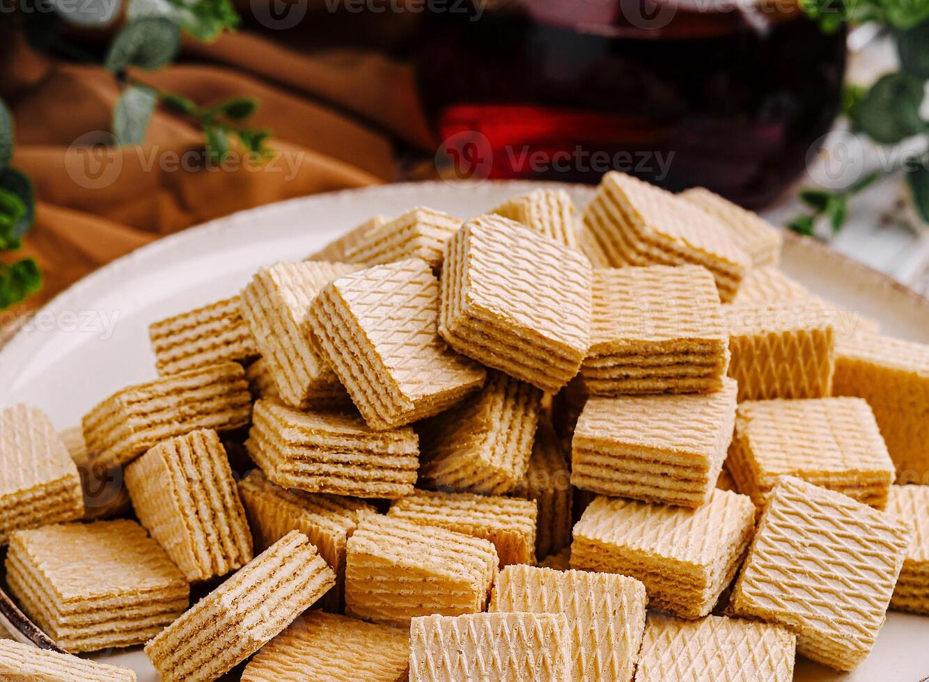 Delightful wafers arranged on a plate with a refreshing drink photo