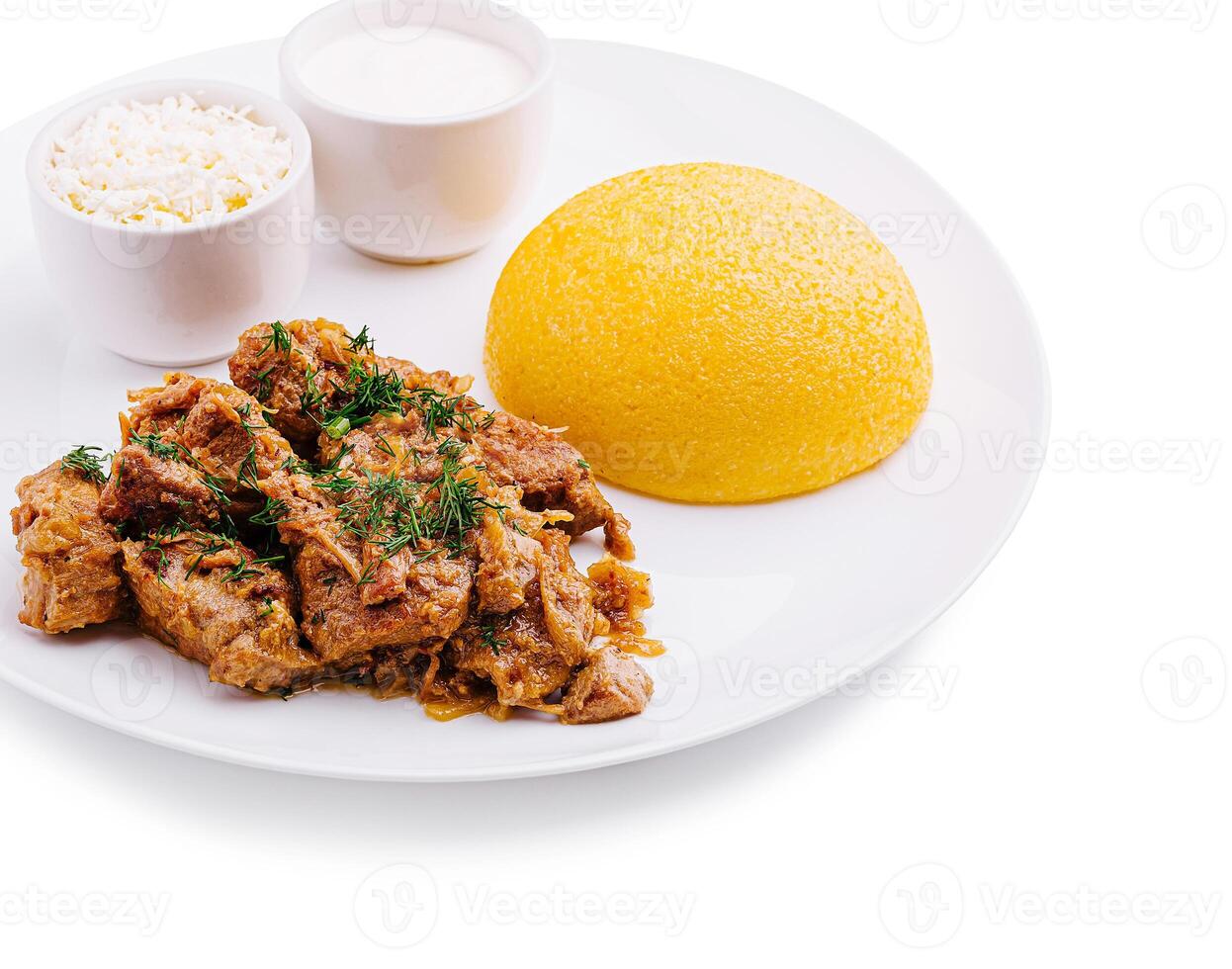 Delicious meal featuring seasoned meat and polenta photo