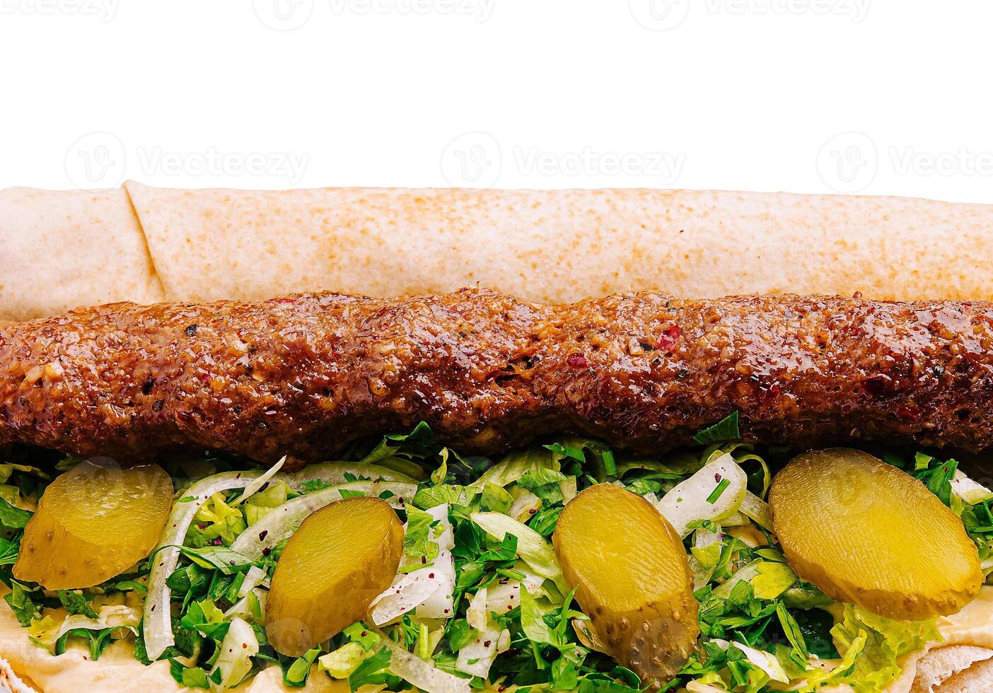 Delicious kebab wrap with fresh vegetables and pickles photo