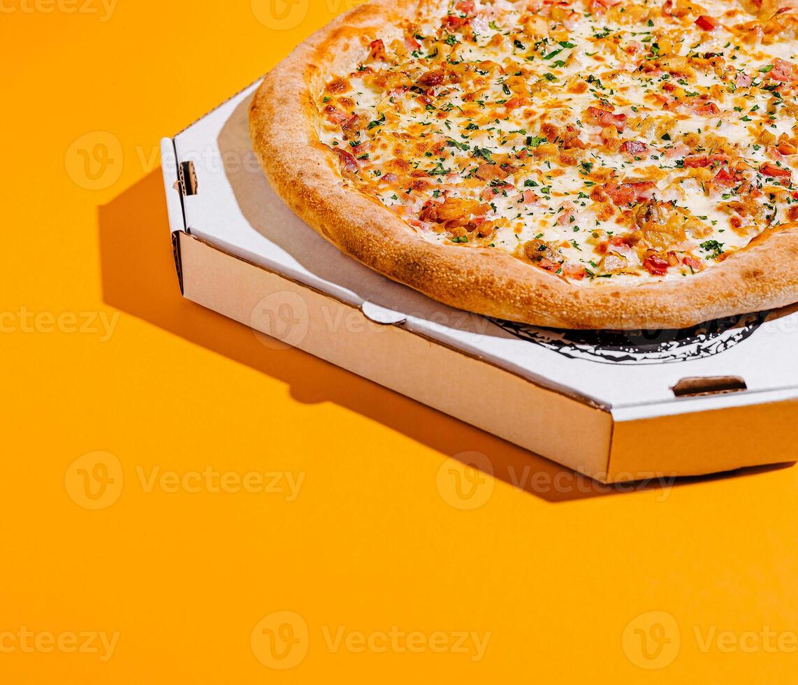 Freshly baked pizza in an open box on a bright surface photo
