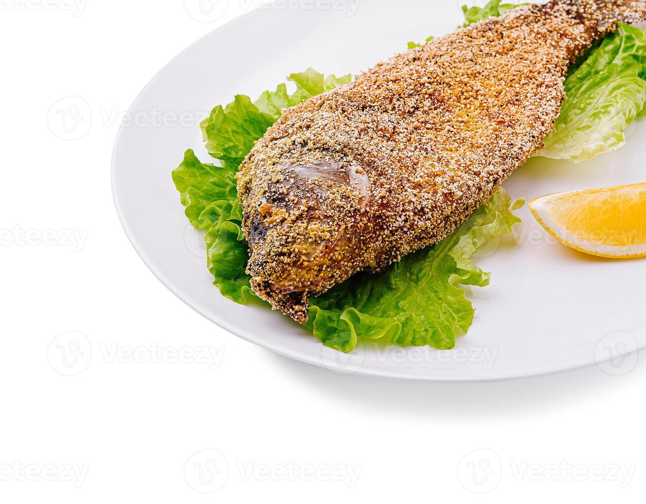 Deliciously fried fish served on a bed of fresh lettuce photo