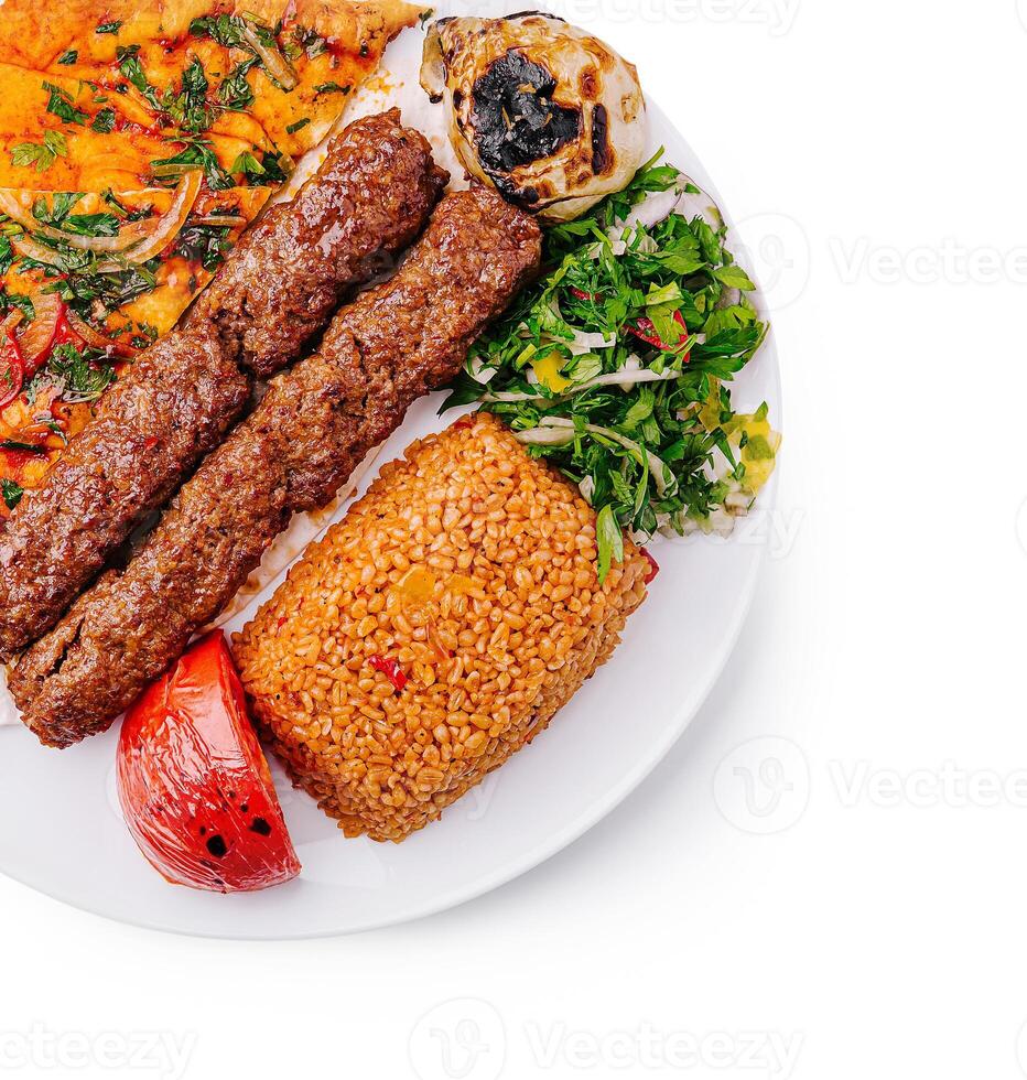 Delicious gourmet kebab platter with fresh sides and rice photo